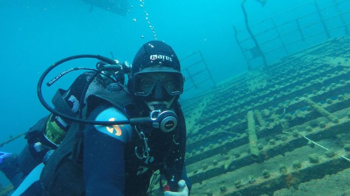 Diver exploring shipwreck in Santorini island
